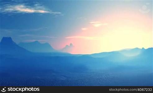 Mountain and valleys covered with blue haze. On the horizon, a halo around the bright glow of the setting sun. White clouds float above the mountains.