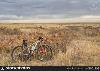 mountain bike on a single track trail in Colorado prairie - Soapstone Prairie Natural Area with last fall colors in late October