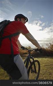 Mountain biker looking at view in countryside
