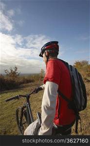 Mountain biker looking at view in countryside