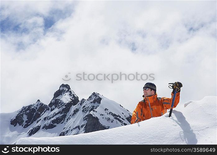 Mountain climber coming over peak