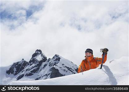 Mountain climber coming over peak