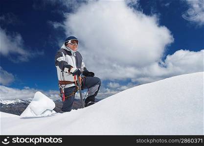 Mountain climber reaching snowy peak