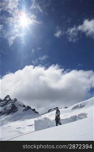 Mountain climber standing on snowy slope
