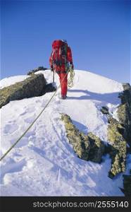Mountain climber walking on snowy mountain