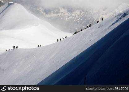 Mountain climbers ascending remote mountain ski slope
