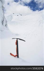 Mountain climbing pick axe in the snow