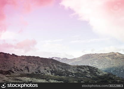 Mountain country under the pastel pink sky. A romantic trip to the mountains. The beauty of nature, dawn over the hills.