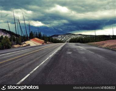 mountain empty road and dramatic rainy sky