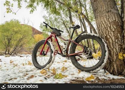 mountain fat bike on a lake shore in fall scenery with snow, Horsetooth Reservoir in northern Colorado