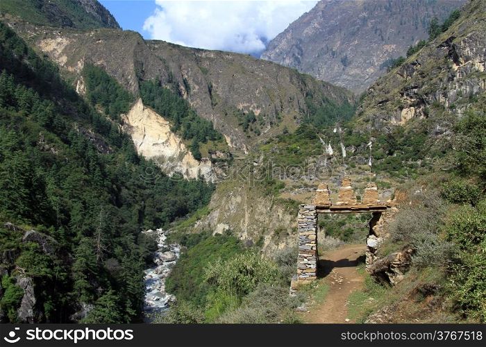 Mountain, footpath and entrance of village in Nepal
