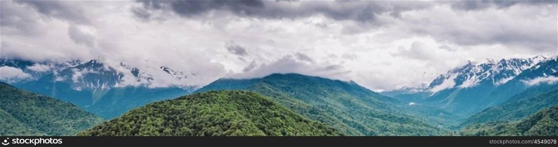 Mountain forest and clouds. Summer panoramic landscape. Mountain forest and clouds