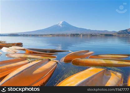 Mountain Fuji and boats in the shore at noon near Fujikawaguchiko, Yamanashi. Five lakes, Japan with blue sky. Nature landscape background