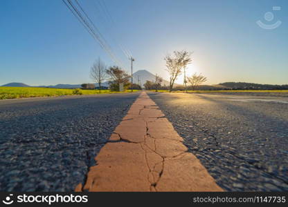 Mountain Fuji and street road with blue sky near Fuji Five Lakes, Fujikawaguchiko, Yamanashi, Japan. Nature landscape background.