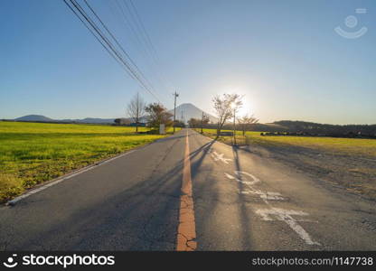 Mountain Fuji and street road with blue sky near Fuji Five Lakes, Fujikawaguchiko, Yamanashi, Japan. Nature landscape background.