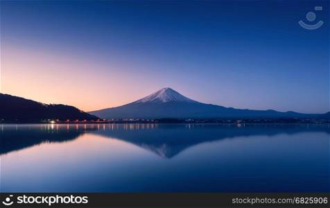 mountain Fuji at dawn with peaceful lake reflection