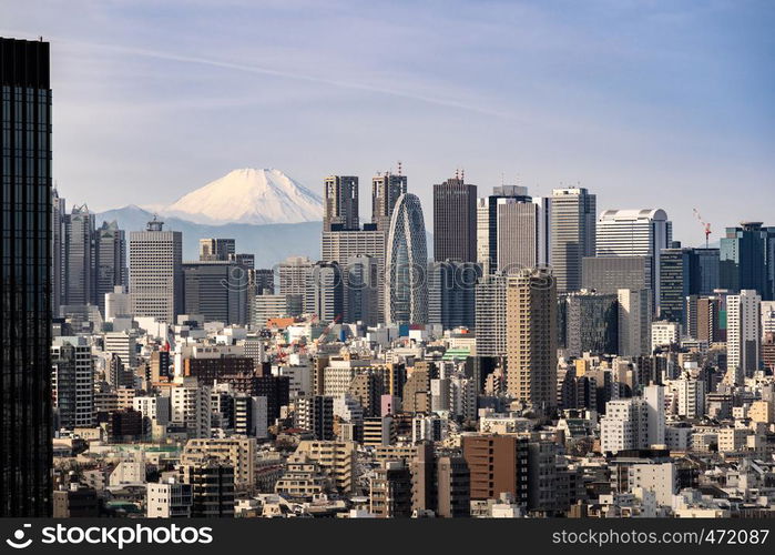 Mountain Fuji with Tokyo skylines and skyscrapers buildings in Shinjuku ward in Tokyo. Taken from Tokyo Bunkyo civic center observatory sky desk.