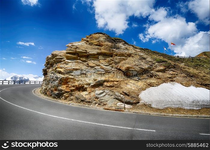 Mountain highway among mountain ranges and blue sky