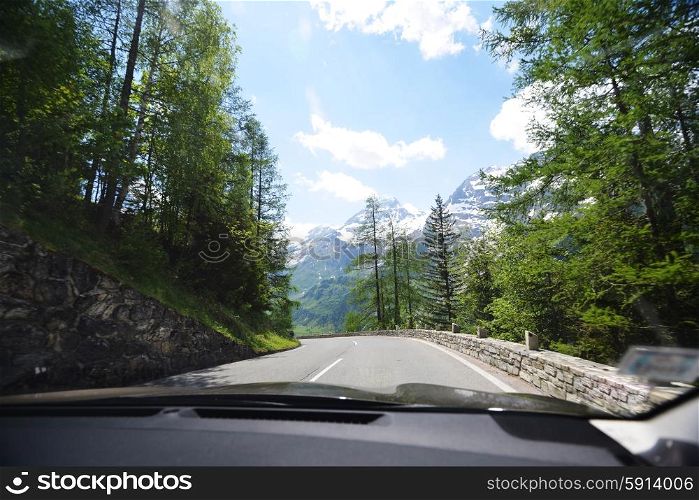 Mountain highway among mountain ranges and blue sky
