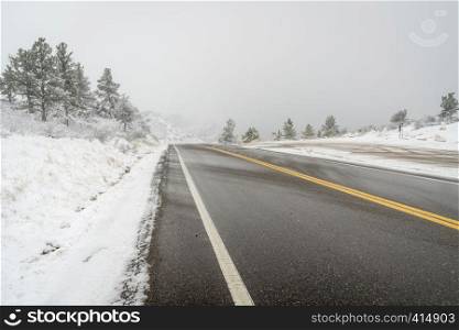 mountain highway in a heavy April snowstorm - Centennial Road near Fort Collins, Colorado
