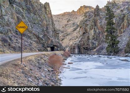 mountain highway with a tunnel - Poudre River canyon in Rocky Mountains in northern Colorado, winter scenery