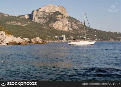 mountain Ilyas-Kaya on the sea and the city of Laspi, Crimea, Ukraine, summer sunny day