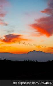 mountain in morocco africa and red sunrise current cables power pylon