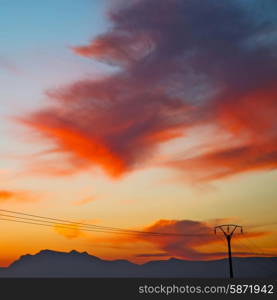 mountain in morocco africa and red sunrise current cables power pylon