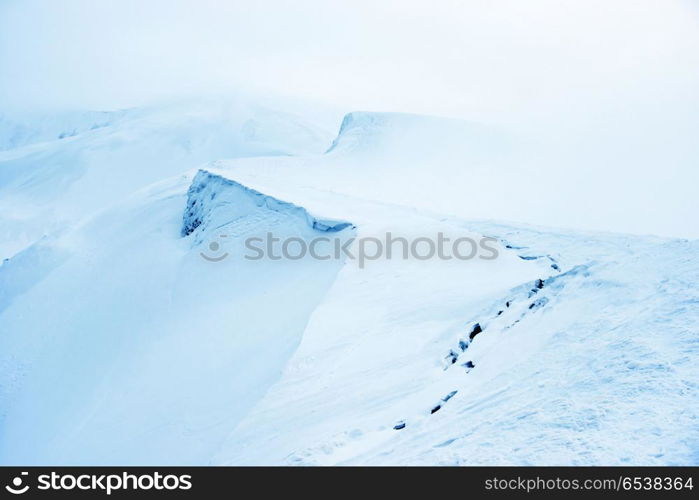 Mountain in snow with fog. Mountain in blue snow with fog. Winter landscape