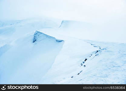 Mountain in snow with fog. Mountain in blue snow with fog. Winter landscape