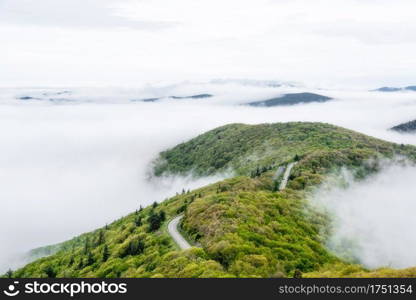 Mountain islands poke through the cloud inversion at Shenandoah National Park as Skyline Drive winds its way through the park.