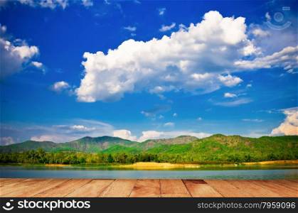 Mountain lake and wooden board background