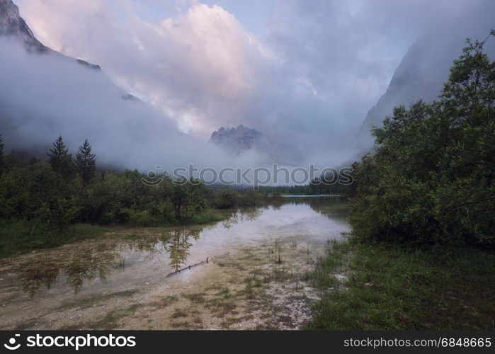 Mountain lake at misty morning. Lago di Landro, Dolomites Alps, Italy