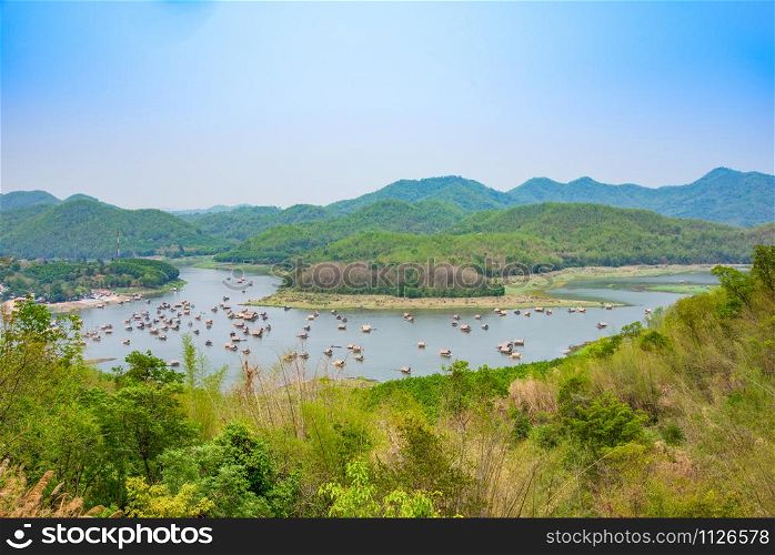 Mountain lake landscape of river green mountain with bamboo houseboat raft floating looking from viewpoint / At HuayKraTing Loei Thailand