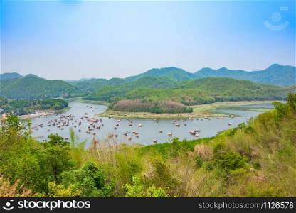 Mountain lake landscape of river green mountain with bamboo houseboat raft floating looking from viewpoint / At HuayKraTing Loei Thailand