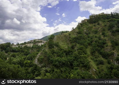 Mountain landscape along the road of Gole del Sagittario, famous canyon in Abruzzo, Italy, L Aquila province. View of Villalago, old village