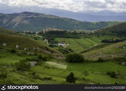 Mountain landscape at Gran Sasso Natural Park, in Abruzzo, Italy, L Aquila province, at springtime (June). View of Santo Stefano di Sessanio, historic village