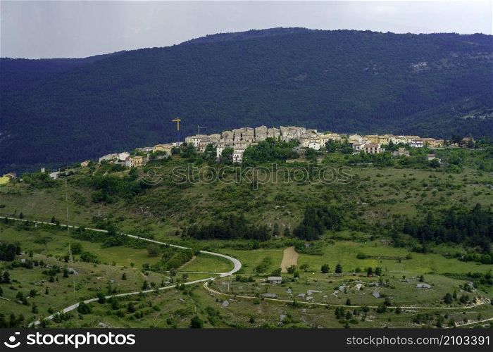 Mountain landscape at Gran Sasso Natural Park, in Abruzzo, Italy, L Aquila province, at springtime (June). View of Castelvecchio Calvisio, historic village