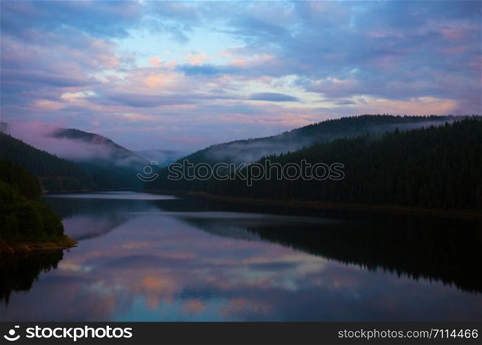Mountain landscape. beautiful mountain lake with reflection on the Sunset