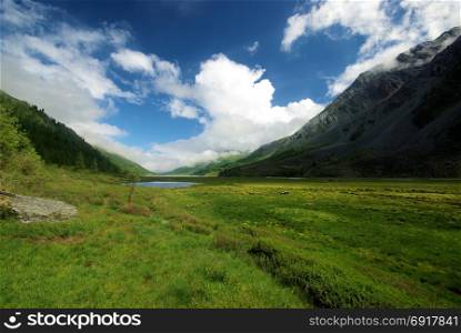 Mountain landscape. Highlands, the mountain peaks, gorges and valleys. The stones on the slopes. Mountain landscape. Highlands, the mountain peaks, gorges and valleys. The stones on the slopes.