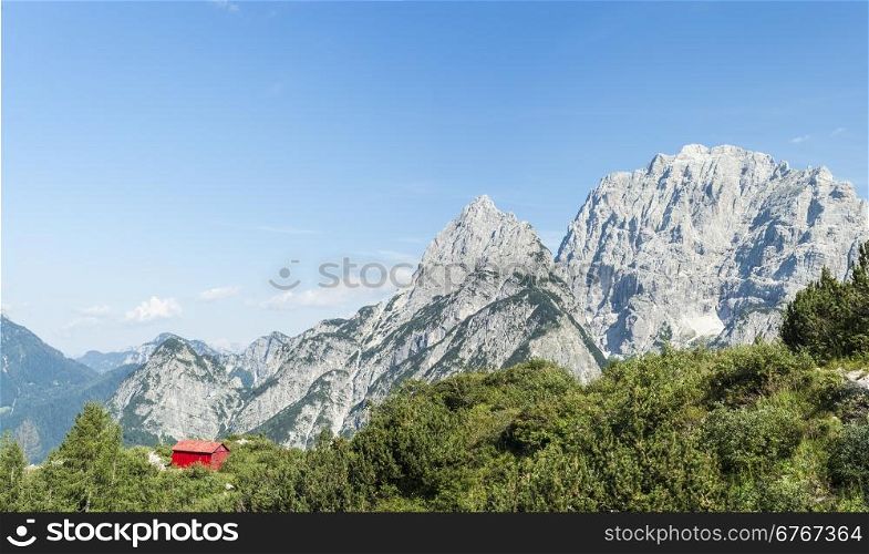 Mountain landscape of the Julian Alps with Alpine shelter in Friuli, Italy