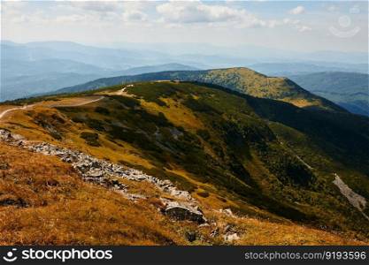 Mountain landscape. Scenic view of mountain peaks, slopes, hills and valleys covered with grass and trees. Panoramic view. Natural scenery. Beautiful background