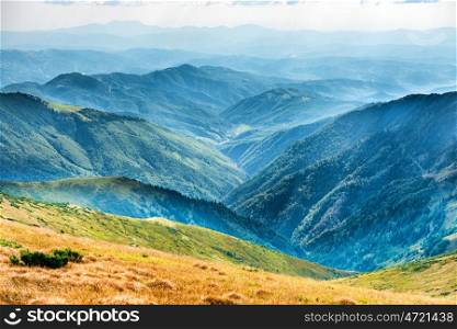 Mountain landscape, valley with peaks and blue hills