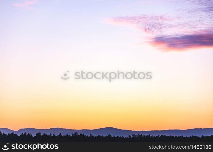 Mountain landscape with colorful vivid sunset on the cloudy sky, natural outdoor travel background.. Mountain landscape with colorful violet - orange sunset