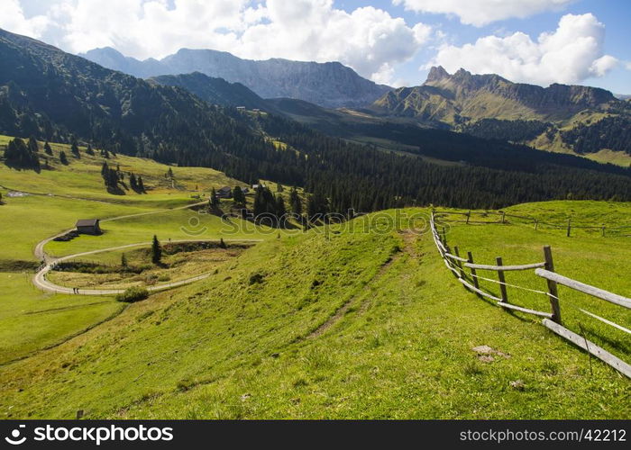 Mountain landscape with wooden fence, shelter and hiking trails