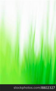 Mountain meadow blurred background. Green juicy fresh grass blurred bokeh background.. Fresh spring greens blurred universal texture for your design