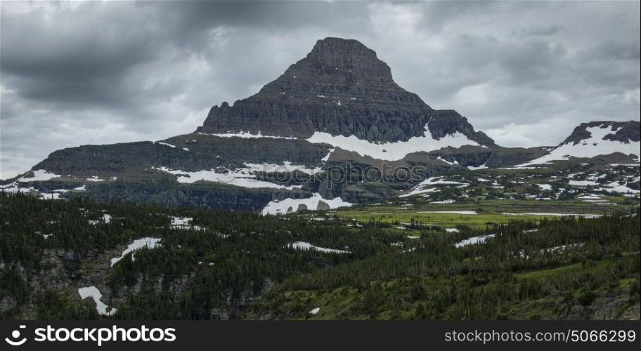 Mountain peak against cloudy sky, Going-to-the-Sun Road, Glacier National Park, Glacier County, Montana, USA
