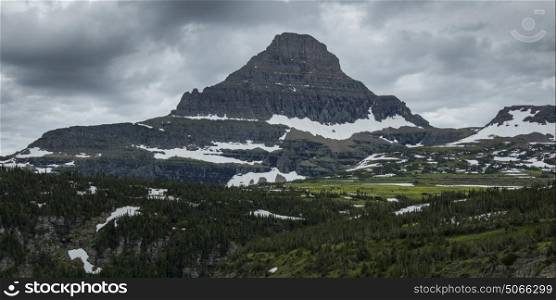 Mountain peak against cloudy sky, Going-to-the-Sun Road, Glacier National Park, Glacier County, Montana, USA