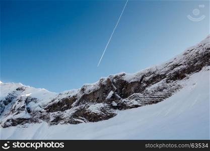 Mountain Peak and Airplane Trail near Megeve in French Alps, France