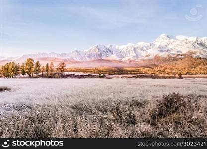 Mountain peak, snowy peak Sunny day. Landscape on the mountain range in pastel colors, autumn weather.